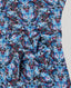 Close-up of a fabric with a blue and pink butterfly pattern on a gray background