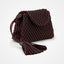 Brown woven handbag with tassels on a light gray background