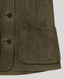 Close-up of an olive green suede jacket showing a buttoned front closure and a large front patch pocket with matching stitching.