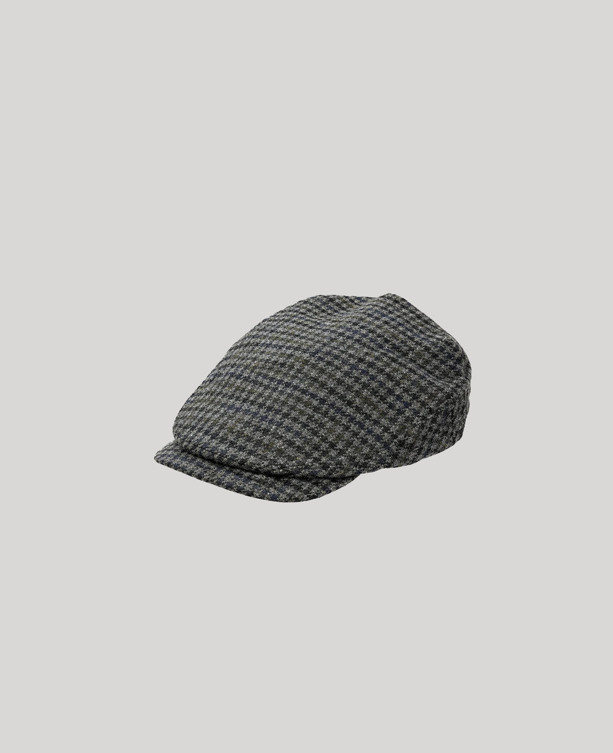 Navy grey flat cap on a light gray background