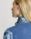 Close-up on ribbed shoulder detail on Model wearing Highgrove Recycled Cashmere Round Neck Tank in Blue with a silk blouse 