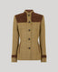 A women's tailored jacket in a tan and brown windowpane tweed, featuring solid brown suede-like shoulder yokes, matching brown cuffs, and a high stand collar, shown against a solid gray background.