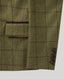 Close-up of an olive green tweed blazer with a brown windowpane check pattern, showing a pocket flap and three dark buttons on the cuff.