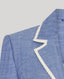 Blue blazer with white trim on a light gray background