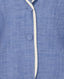 Close-up of a blue blazer with white piping detail