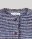 Close-up of a textured fabric with buttons on a light gray background