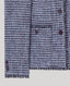 Close-up of boucle fabric with covered buttons on a light gray background