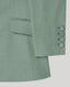 Green suit jacket with buttons on a light gray background