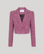 Pink boucle blazer on a light gray background