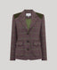 A women's tailored blazer in a muted plum-purple and green plaid pattern, featuring olive green shoulder yokes and a green inner lining, shown against a solid light gray background.