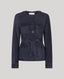Navy blue suede jacket with button details on a light gray background
