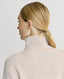 Close-up of back of Model wearing Lambswool High-Neck Sweater in Swansdown Ivory showing Fully fashioned rib detail at back neck yoke