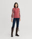 Model wearing Lambswool V-Neck Tank Cinder Orange with silk blouse, jeans and brown boots