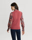 Back of Model wearing Lambswool V-Neck Tank Cinder Orange with silk blouse and jeans 
