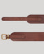 Detail of brown leather belt with gold buckle