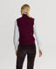 Back of model wearing Madeline Cashmere Zip Up Tank in Oxblood Red with corduroy trousers. 