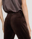 Back of model wearing Mayfair Velvet Flare Trousers in Chocolate Brown 
