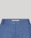 Close-up of blue pants with a brand label on a light gray background