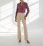 Model wearing a pink boucle blazer and beige pants on a white background