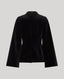 A black velvet cape shown from the back, featuring long sleeves and a structured collar, photographed against a solid light gray background.