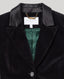 Close-up of a black velvet cape with satin lapels and a green satin lining, featuring a visible 'REALLY WILD LONDON' neck label.