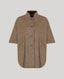 A brown textured wool cape jacket with a stand collar, three-quarter sleeves, and front buttons, shown against a solid gray background.