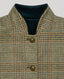 Close-up of a cape with a high stand collar, featuring a beige, brown, and blue houndstooth pattern, bronze buttons, and a dark teal velvet inner lining.