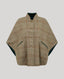 A cropped, wide-sleeved poncho-style jacket in a beige and brown plaid pattern with a dark green inner lining, shown against a solid light gray background.