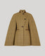 A camel-colored windowpane check tweed cape with brown leather trim on the collar, buttonholes, and pocket flaps, displayed against a solid gray background.