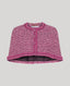 Pink boucle cape on a light gray background