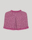 Pink boucle cape on a light gray background