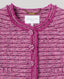 Close-up of a pink boucle cape with 'Really Wild London' label.