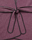 A close-up of a textured herringbone fabric in a muted plum-purple color, tied with a thin black leather or faux-leather bow at the center.