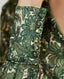 Close-up on covered buttons on cuff of Oak Print Silk Open Neck Shirt in Green and Cream 