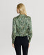 Back of model wearing Oak Print Silk Open Neck Shirt in Green and Cream with black jeans 