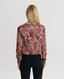 Back of Model wearing the Peacock Silk Open Neck Shirt in Coral Orange
