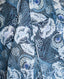 Close-up on ice blue peacock print on sleeveless silk blouse with neck tie in 
