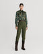 Model wearing Plumage Feather Print Silk Fixed Tie Neck Blouse in green with tweed trousers and boots 