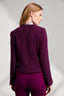 Back of model wearing purple boucle jacket and purple trousers 