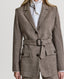 Close-up of belt on Model wearing Highclere Wool Safari Jacket in Taupe Camel Check with silk blouse 
