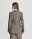 Back of Model wearing Highclere Wool Safari Jacket in Taupe Camel Check