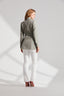Back of Model wearing Sage Green Safari Jacket with tortoiseshell buttons and belt buckle with white trousers and silk blouse 