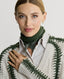 Model wearing Jasmine Lambswool V-Neck Sweater in Swansdown Ivory with Loden Green Stitch 