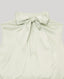 Light green sleeveless blouse with a large bow detail on a light grey background