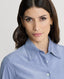 Close-up on Model wearing Spencer-Stretch Corduroy Shirt in Ice Blue featuring mother of pearl buttons 