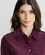 Close-up on model wearing Spencer-Stretch Corduroy Shirt in Oxblood Burgundy featuring mother of pearl buttons