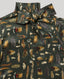 A close-up of a dark olive green satin shirt with an all-over feather print in brown, beige, and white, featuring a large bow at the collar.