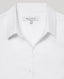 White shirt with collar and label on a light gray background