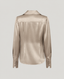 A long-sleeve satin blouse shown from the back, in a champagne beige color, against a light gray background.