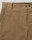 Close-up of tan corduroy trousers showing the waistband, belt loops, button closure, and front pocket.